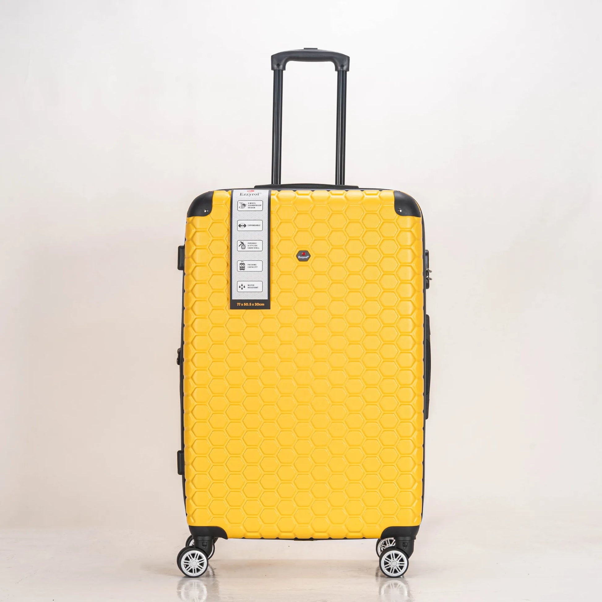 Yellow suitcase with a patterned design on a light beige background