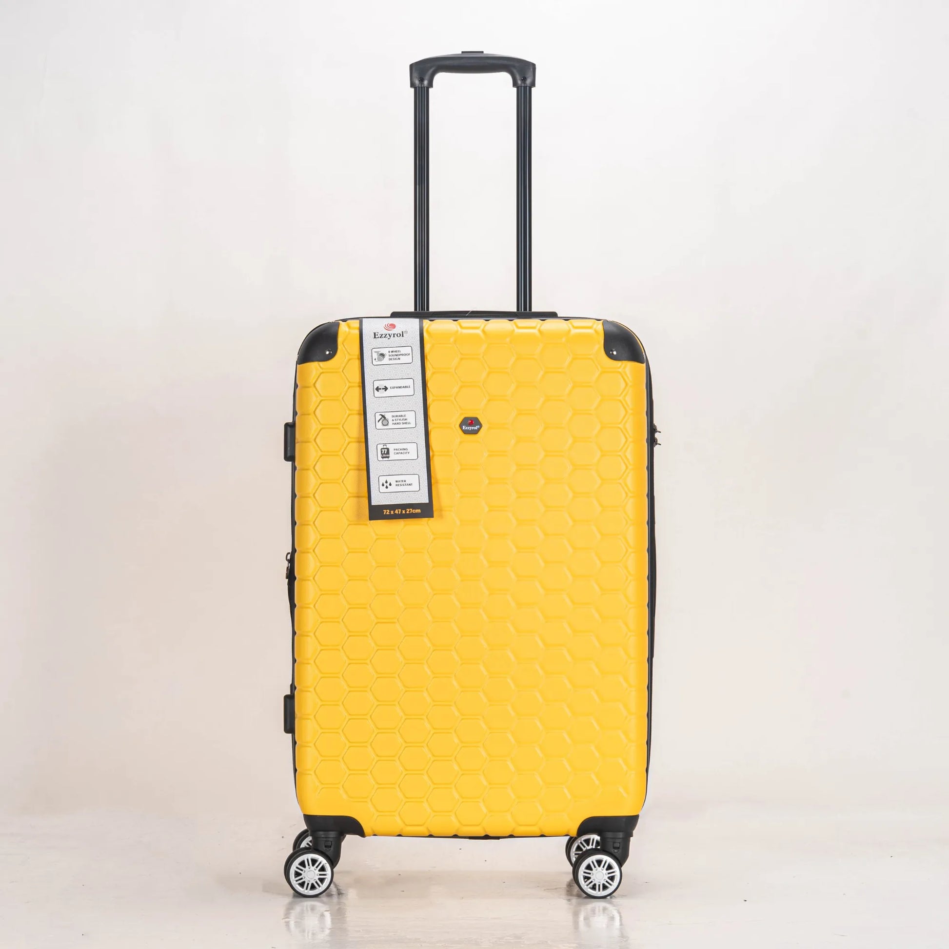Yellow suitcase with a brand label on a light gray background