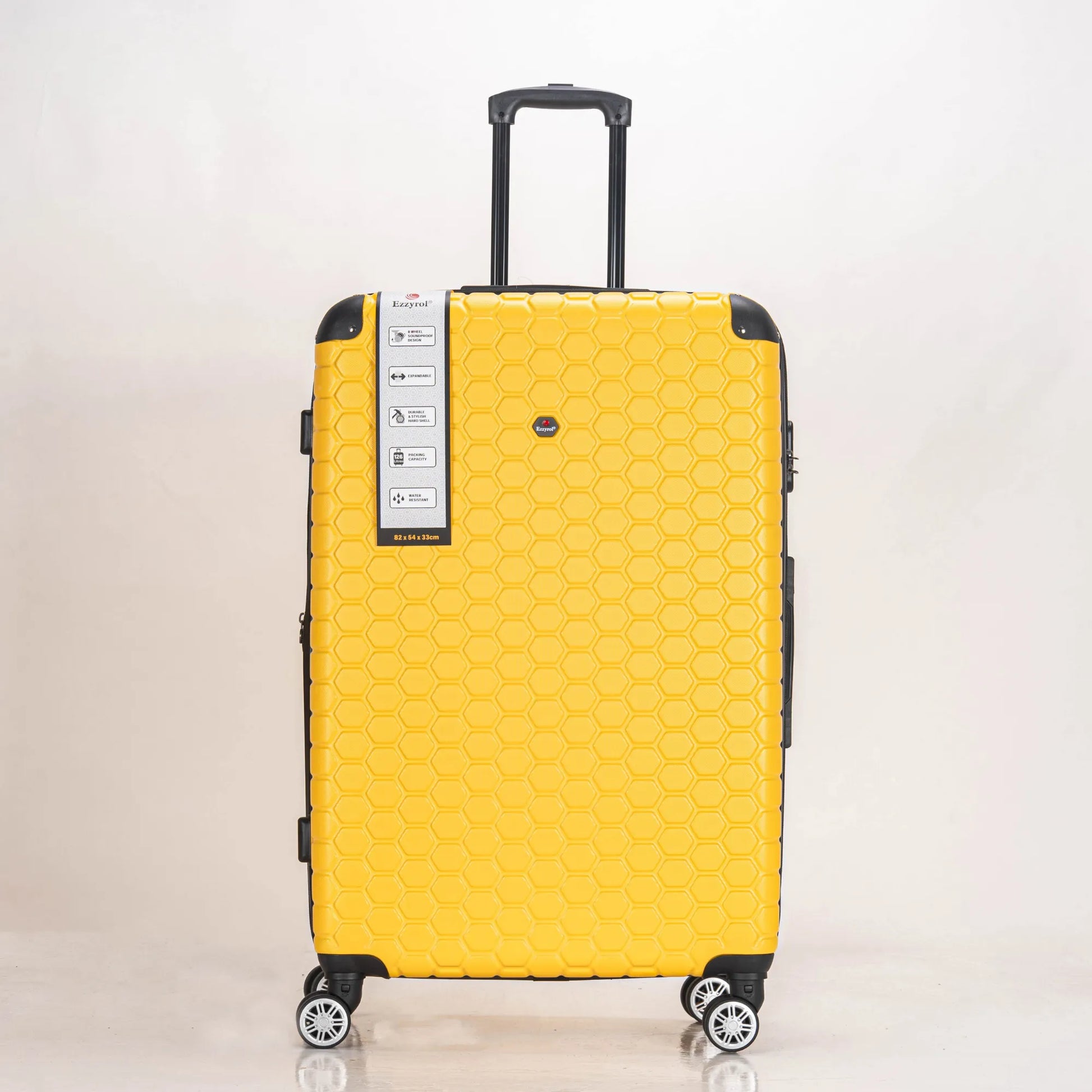 Yellow suitcase with a honeycomb pattern on a light beige background