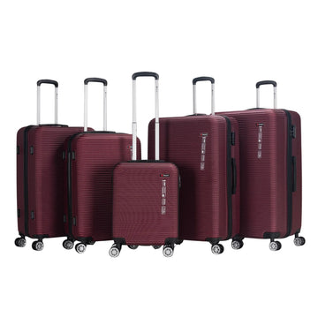 Set of five maroon suitcases of different sizes on a white background