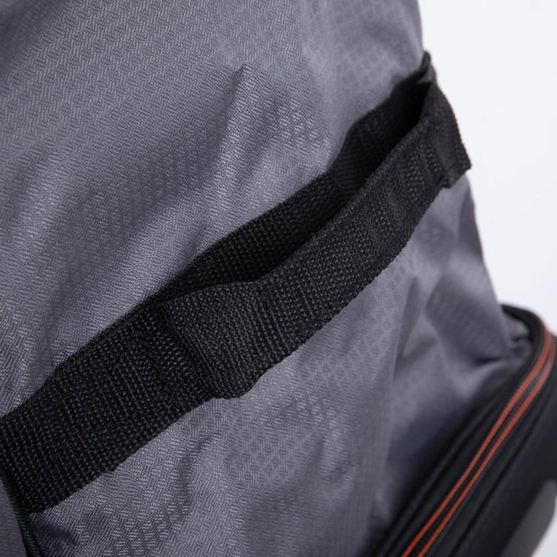 Close-up of a gray bag with a black strap on a white background