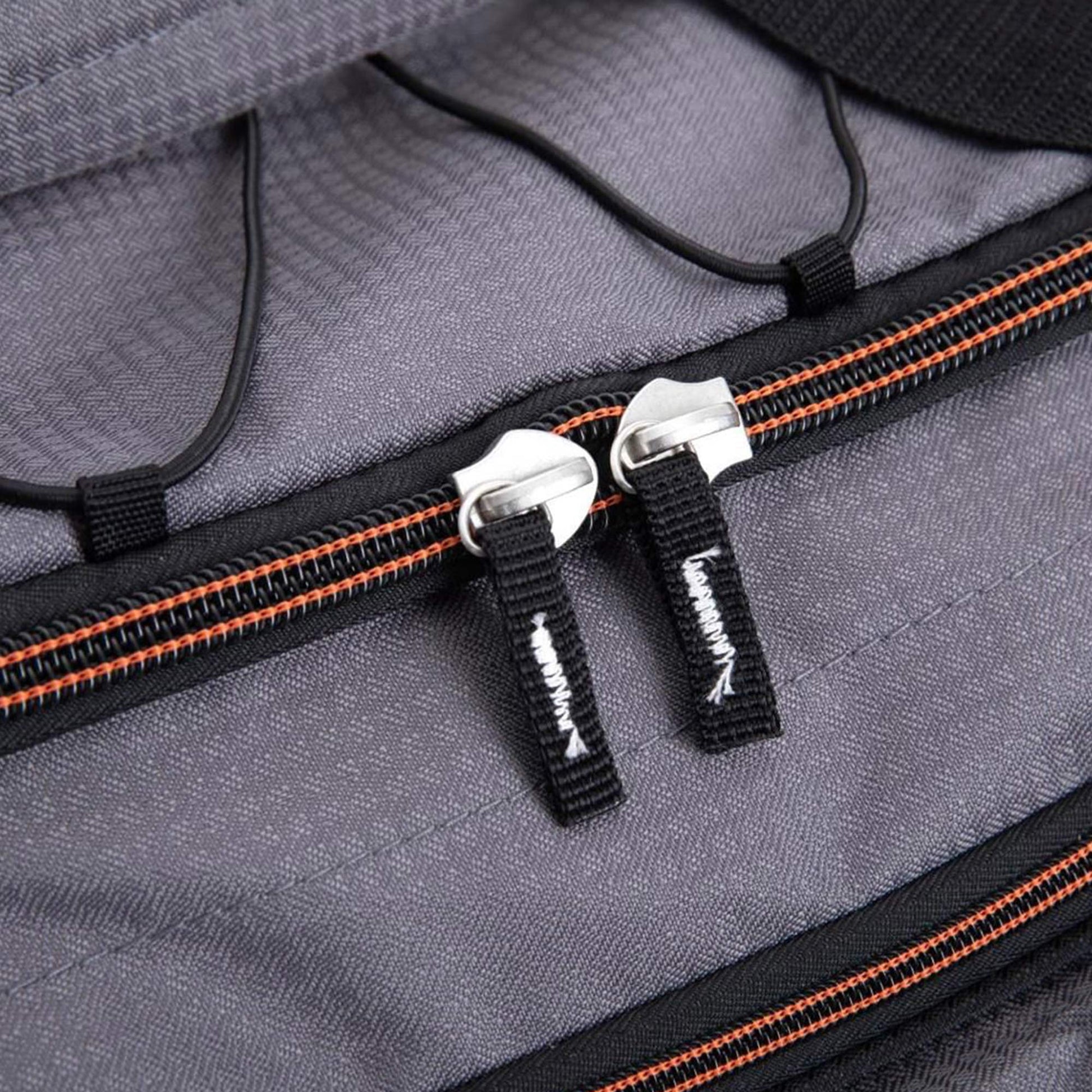 Close-up of a gray bag with orange zipper details
