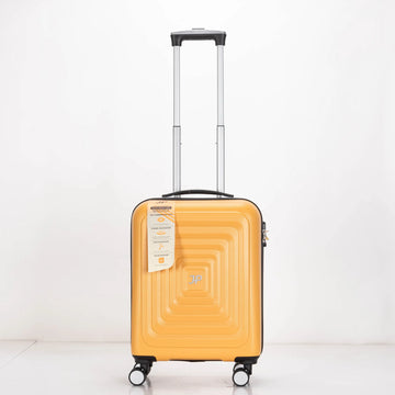 Yellow suitcase with a geometric pattern on a white background