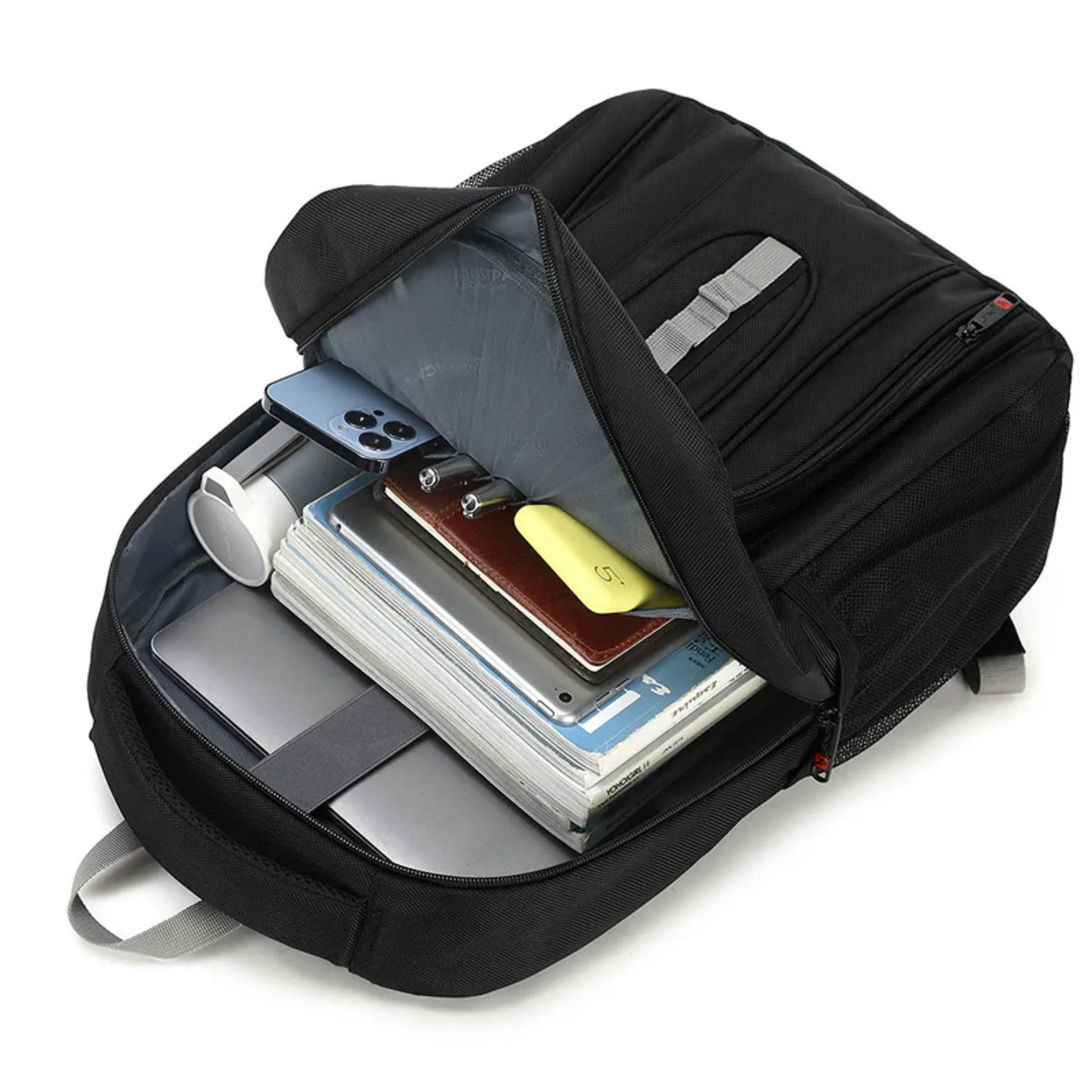Black backpack with compartments holding electronic devices on a white background