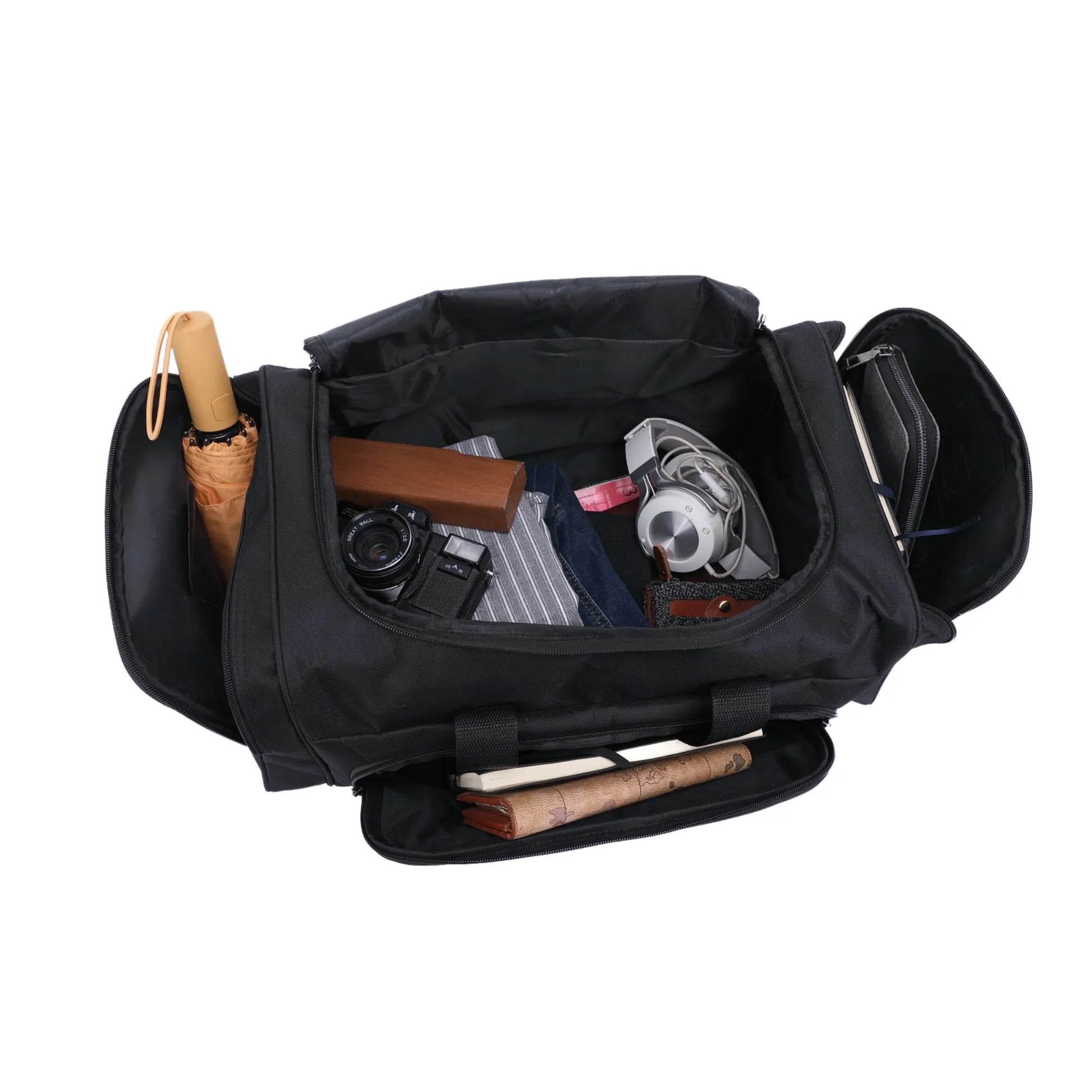 Black duffel bag with various items including a camera, rolled-up papers, and a rolled-up rug on a white background.