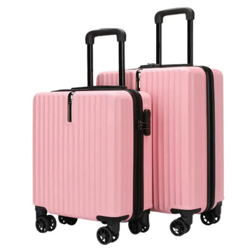 Set of three pink suitcases with black handles and wheels on a white background